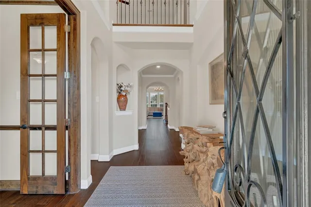 a view of a hallway with wooden floor and windows