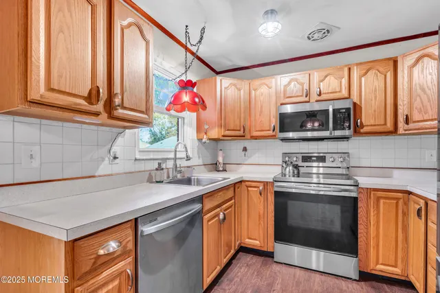 a kitchen with stainless steel appliances granite countertop a sink stove and microwave