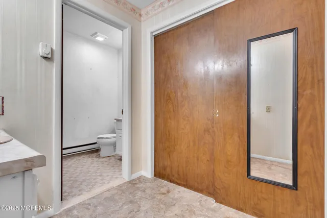 a bathroom with a toilet and a glass door