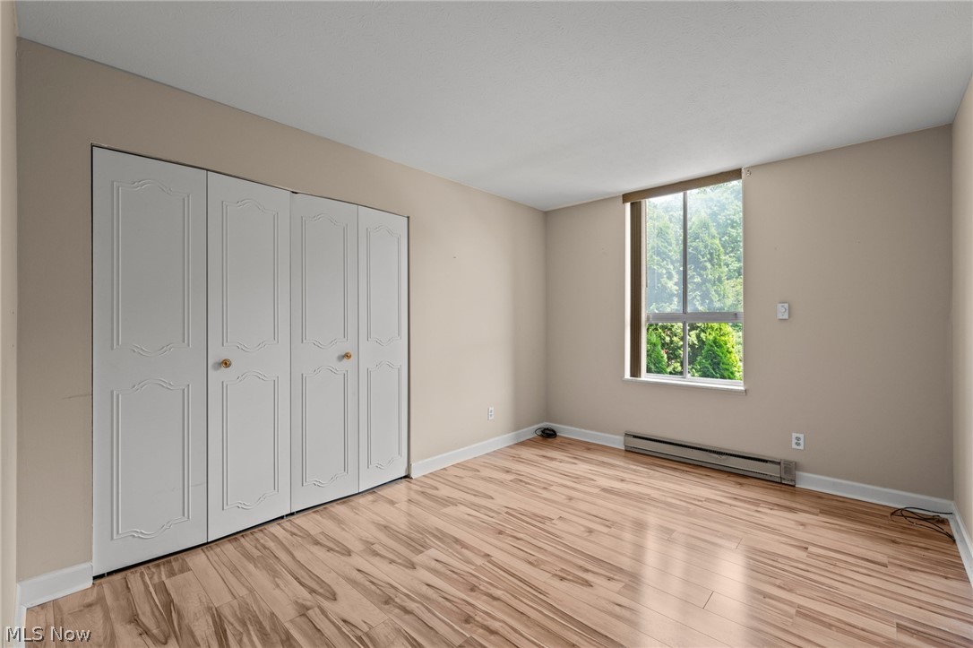 3064 Kent Road, Unit 101 Stow, OH 44224 - Photo 23 of 40 Room featuring wood-finish flooring, neutral wall tones, and a large window