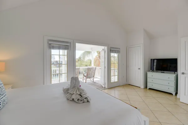 a room with a bed and a television