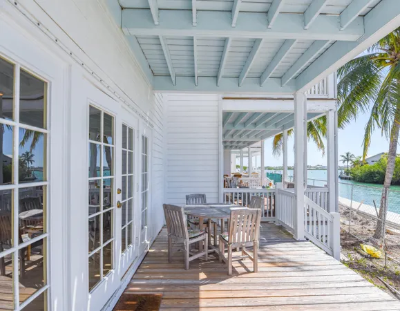 a view of a patio with table and chairs and wooden floor