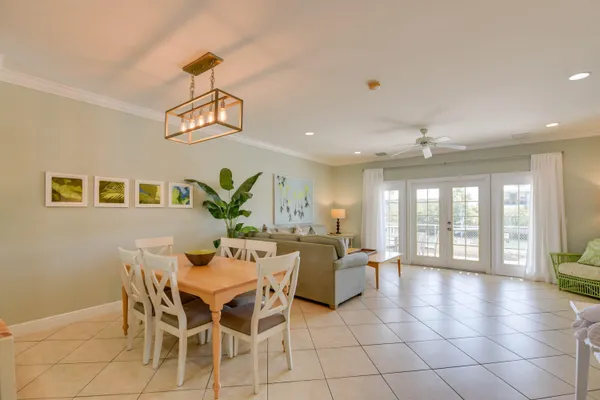 a view of a dining room with furniture wooden floor and chandelier