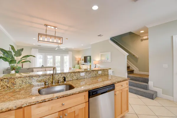 a kitchen with granite countertop a sink and a wooden cabinets
