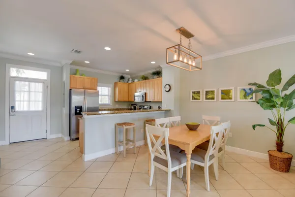 a view of a dining room with furniture and a chandelier