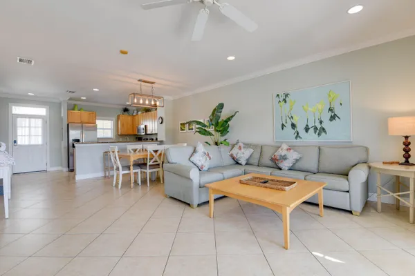 a living room with furniture and view of kitchen