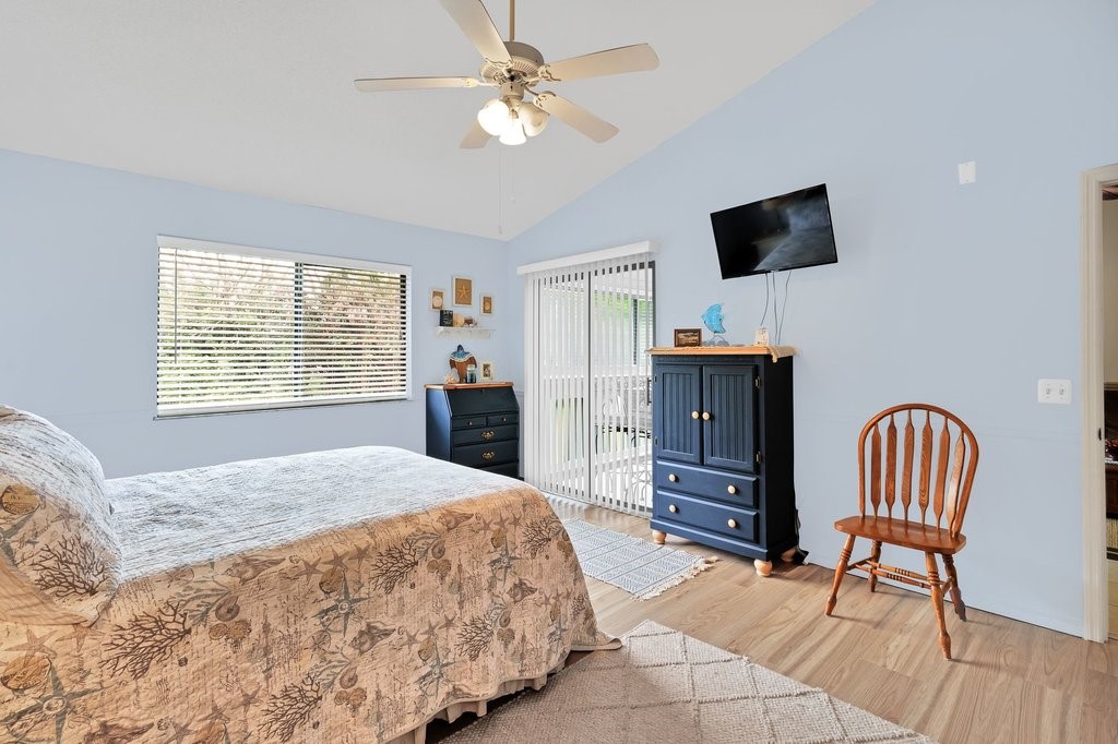 9637 Riverside Drive, Unit 3 Sebastian, FL 32958 - Photo 14 of 36 a bedroom with a bed and a television in it