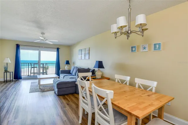 a living room with furniture a chandelier and a table