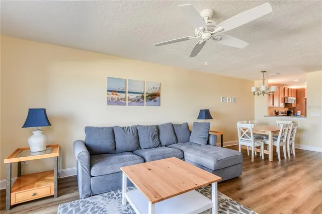 a living room with furniture a rug and a chandelier