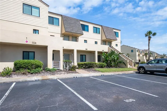 a car parked in front of a white building