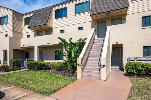 a view of a house with wooden fence and plants