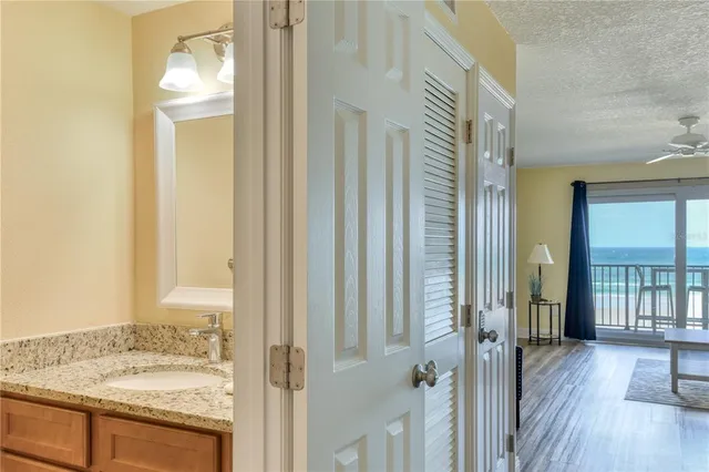 a bathroom with a granite countertop sink and a mirror