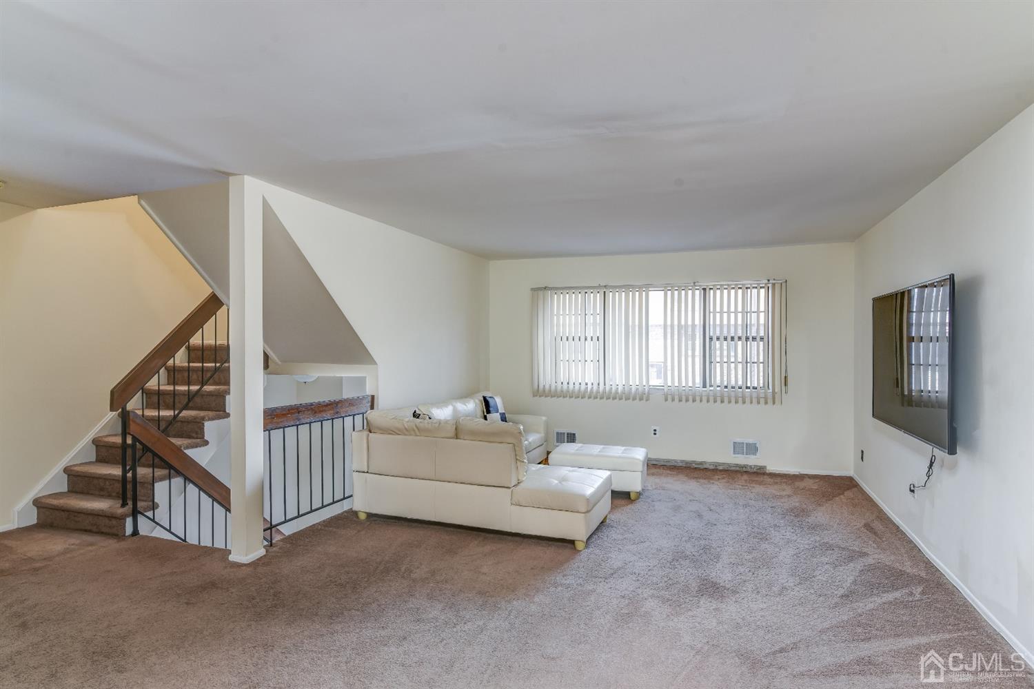 6902 Hana Road Edison, NJ 08817 - Photo 2 of 24 a view of livingroom with furniture and stairs