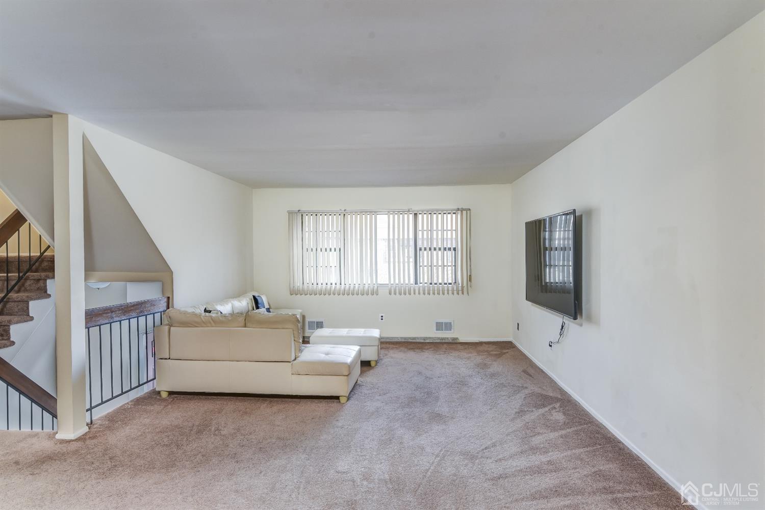 6902 Hana Road Edison, NJ 08817 - Photo 21 of 24 a living room with furniture and a flat screen tv