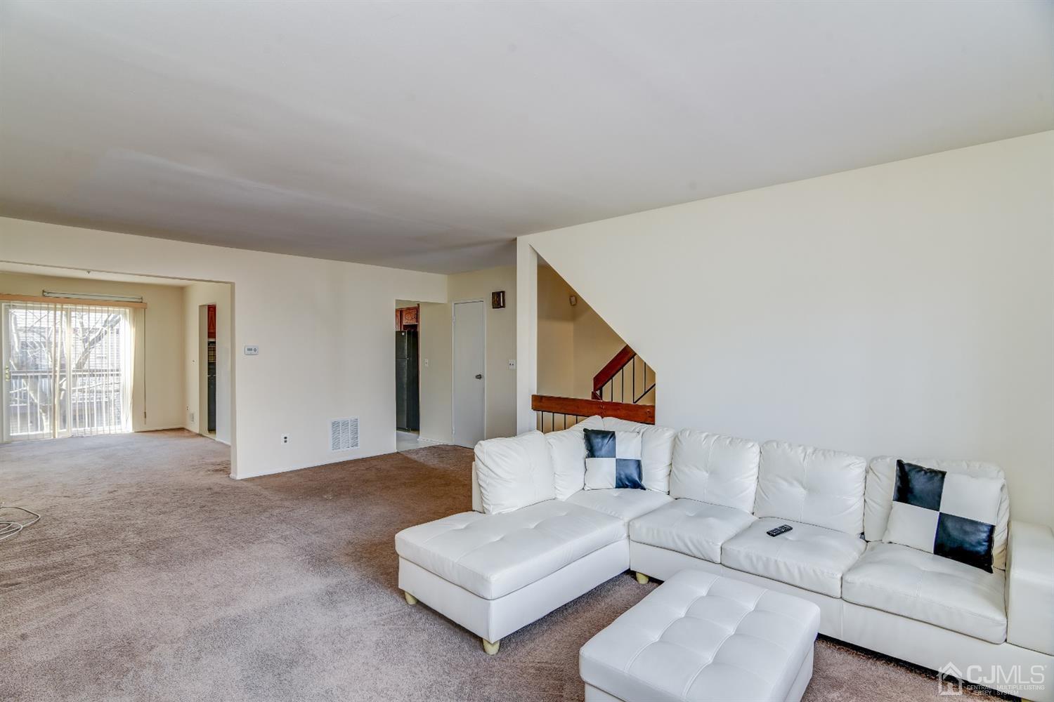 6902 Hana Road Edison, NJ 08817 - Photo 4 of 24 a living room with furniture and a night stand
