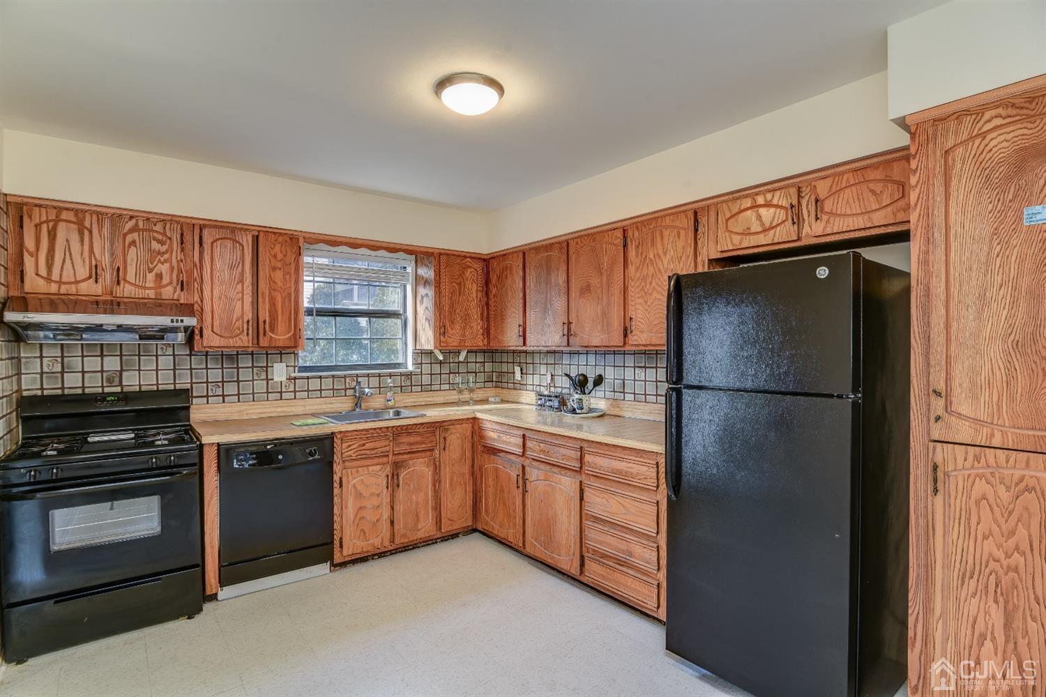 6902 Hana Road Edison, NJ 08817 - Photo 7 of 24 a kitchen with stainless steel appliances a refrigerator and a stove top oven