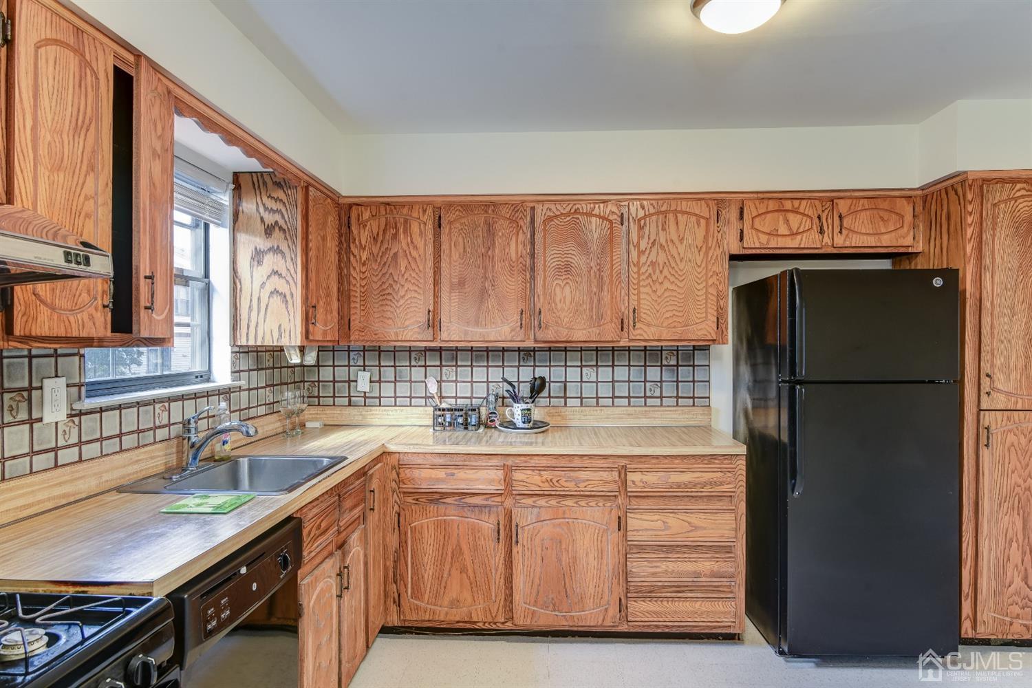 6902 Hana Road Edison, NJ 08817 - Photo 8 of 24 a kitchen with a refrigerator and a sink