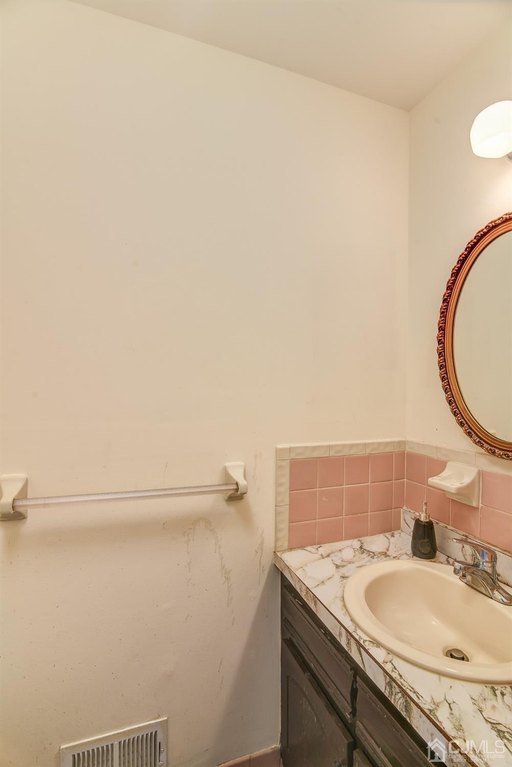 6902 Hana Road Edison, NJ 08817 - Photo 9 of 24 a bathroom with a sink and a mirror