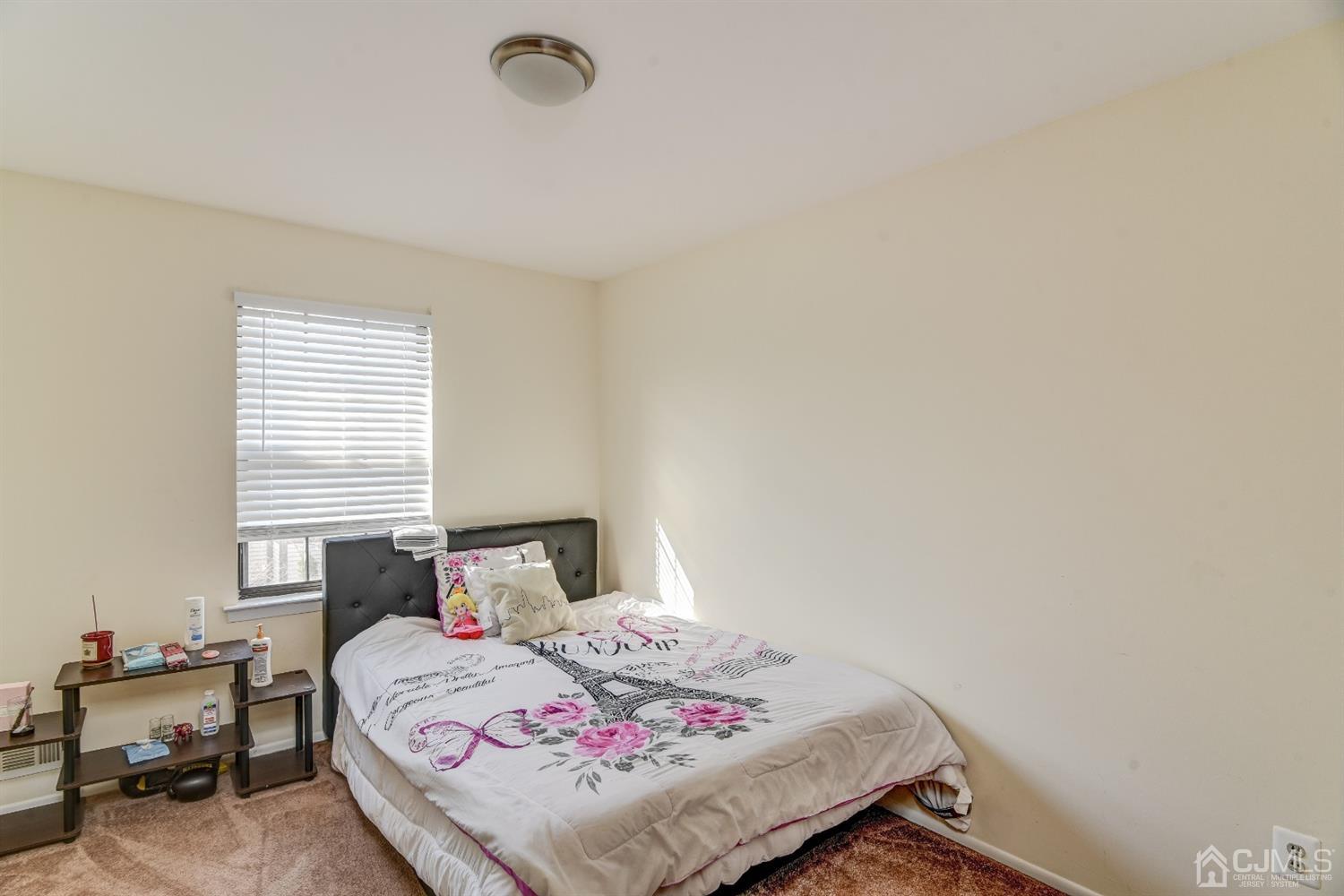 6902 Hana Road Edison, NJ 08817 - Photo 10 of 24 a bedroom with a bed and a window