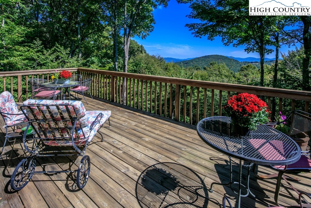 304 Lakeledge Road Beech Mountain, NC 28604 - Photo 1 of 42 a view of a chairs and tables on the roof deck