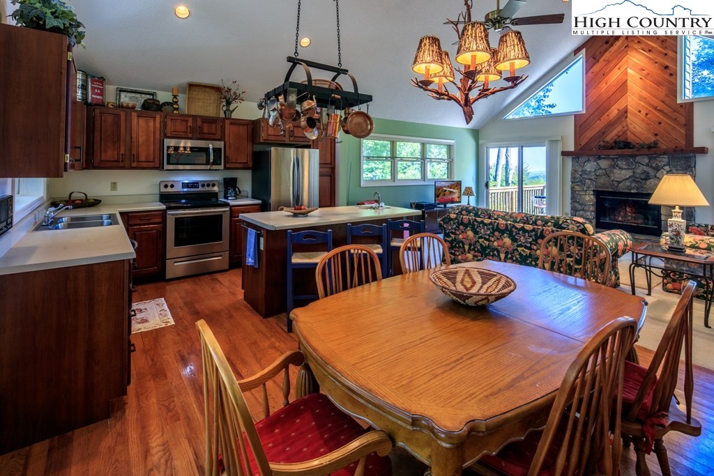 304 Lakeledge Road Beech Mountain, NC 28604 - Photo 12 of 42 a view of a dining room with furniture a chandelier and wooden floor
