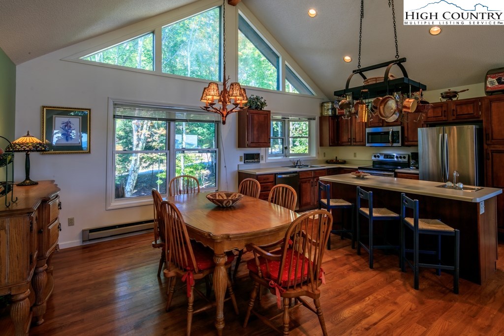 304 Lakeledge Road Beech Mountain, NC 28604 - Photo 13 of 42 a view of a dining room with furniture window and wooden floor