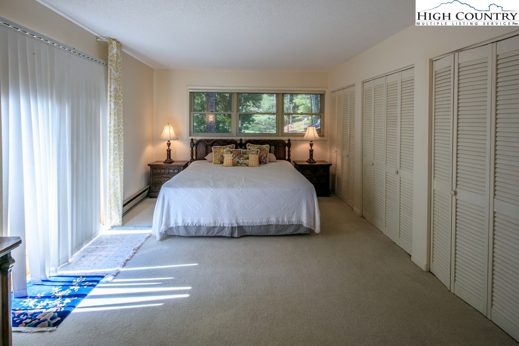 304 Lakeledge Road Beech Mountain, NC 28604 - Photo 17 of 42 a bedroom with a bed and a window