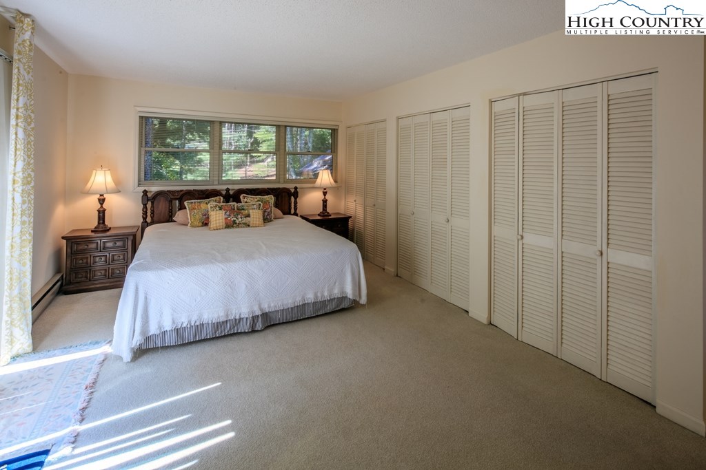 304 Lakeledge Road Beech Mountain, NC 28604 - Photo 18 of 42 a bedroom with a bed and a window