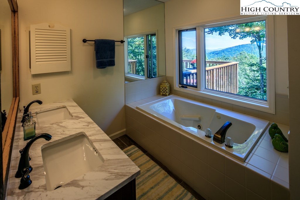 304 Lakeledge Road Beech Mountain, NC 28604 - Photo 20 of 42 a bed sitting in a bedroom next to a window