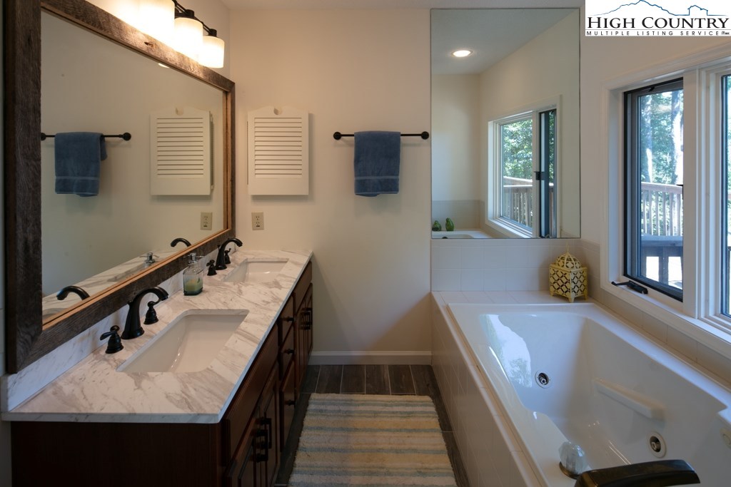 304 Lakeledge Road Beech Mountain, NC 28604 - Photo 21 of 42 a bathroom with a sink and mirror