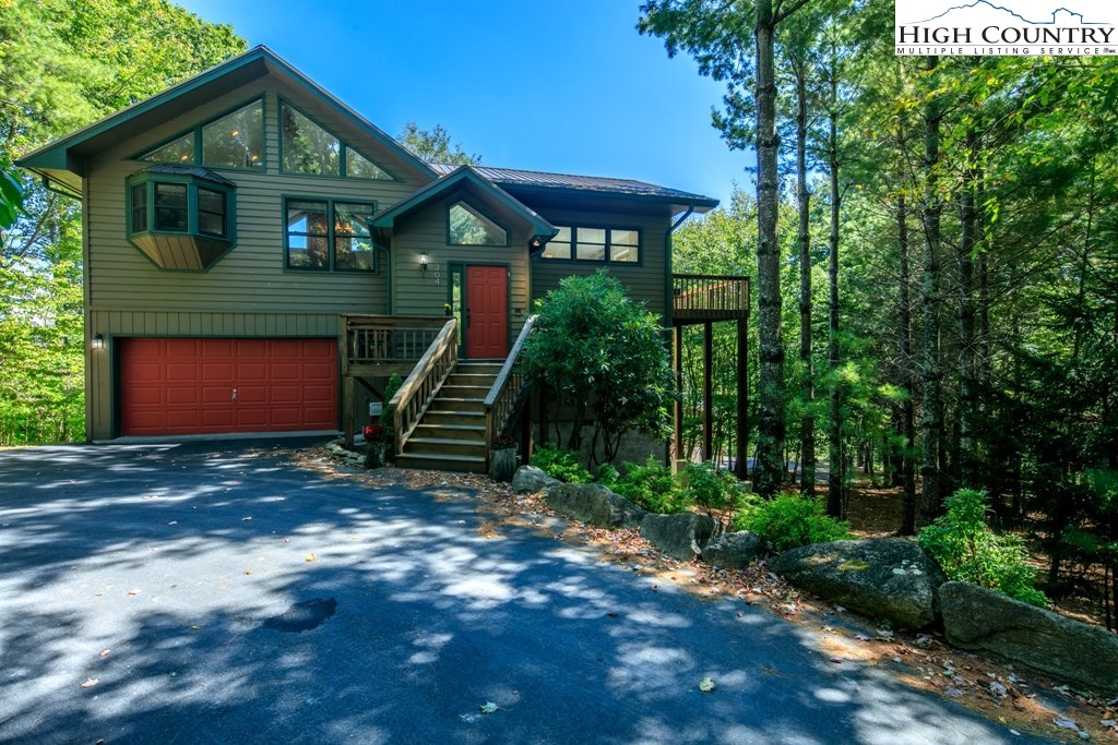 304 Lakeledge Road Beech Mountain, NC 28604 - Photo 3 of 42 a front view of a house with a yard