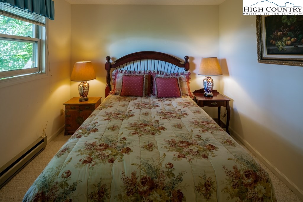 304 Lakeledge Road Beech Mountain, NC 28604 - Photo 33 of 42 a bedroom with a bed and window