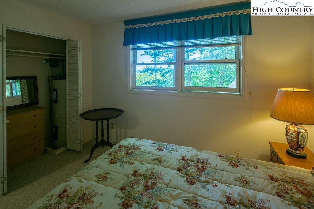 304 Lakeledge Road Beech Mountain, NC 28604 - Photo 34 of 42 a bedroom with a bed and a window