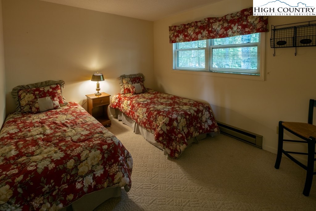 304 Lakeledge Road Beech Mountain, NC 28604 - Photo 35 of 42 a bedroom with two beds and a night stand