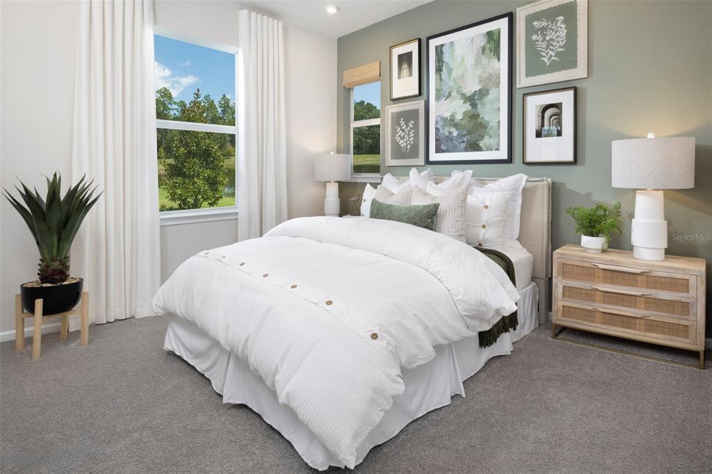 18443 Green Garden Venice, FL 34293 - Photo 3 of 40 a spacious bedroom with a bed and a window