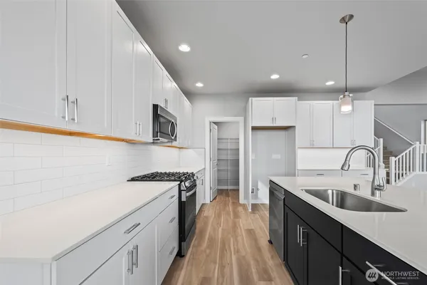a view of kitchen with kitchen island wooden floor and window
