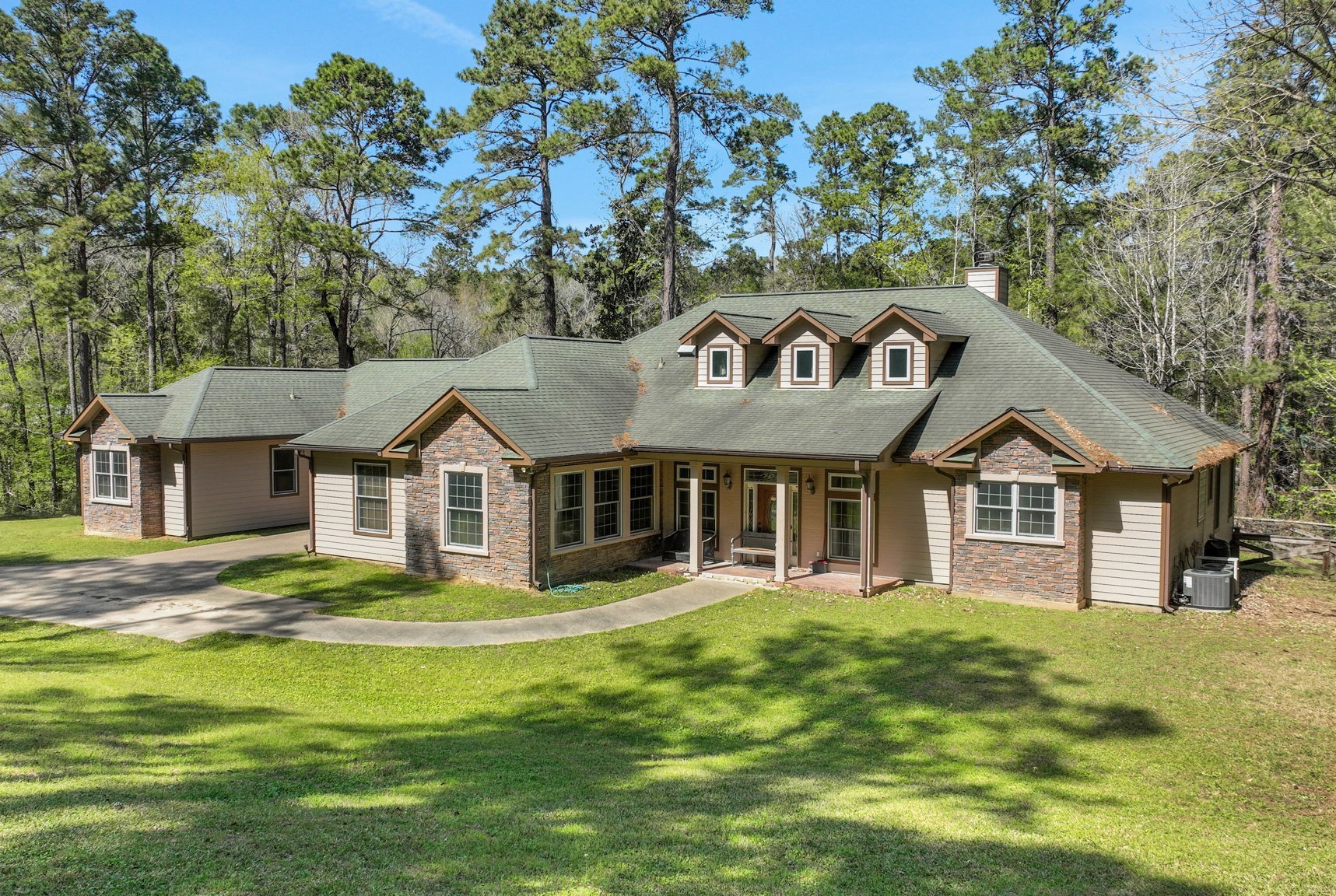 250 Critter Creek Road Coldspring, TX 77331 - Photo 6 of 48 The main home has a guest wing on the left side with a one car Porte-cochère in between