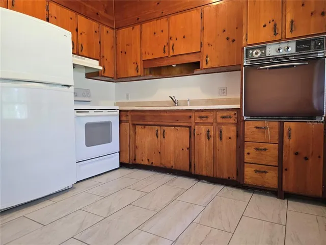 a kitchen with stainless steel appliances granite countertop a sink and a stove