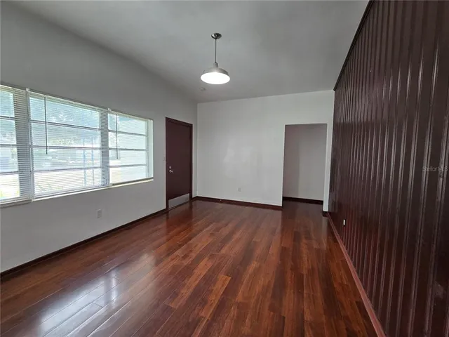 wooden floor in an empty room with a window