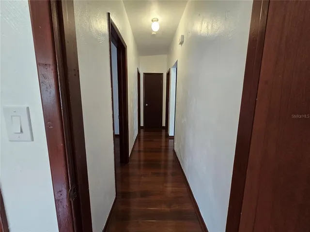 a view of hallway with wooden floor