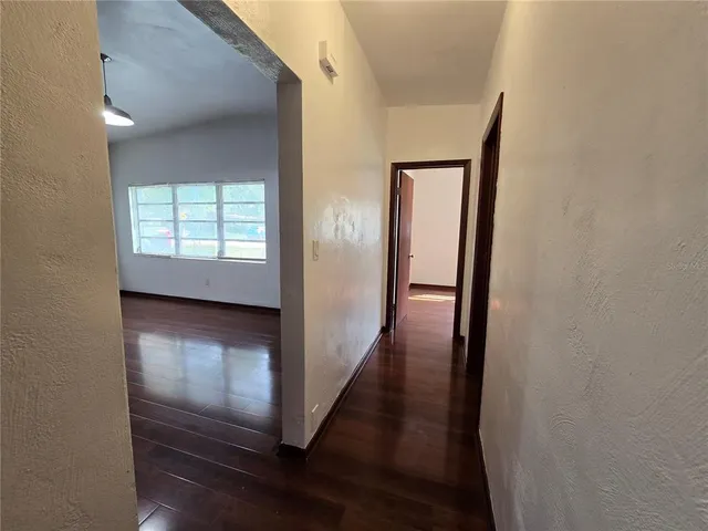 a view of hallway with wooden floor