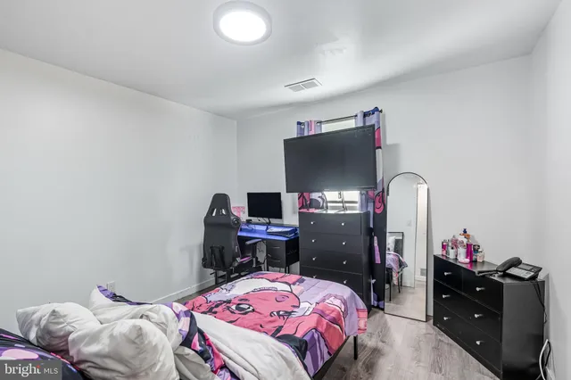 a bedroom with a bed and a desk
