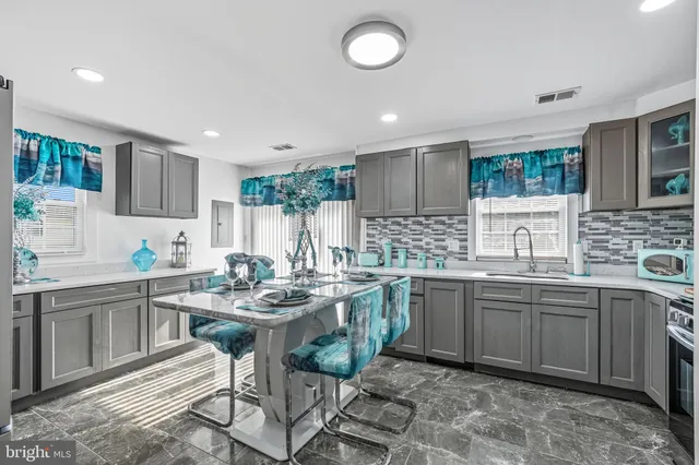 a kitchen with stainless steel appliances granite countertop a sink and cabinets