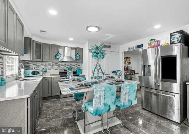 a kitchen with refrigerator and cabinets