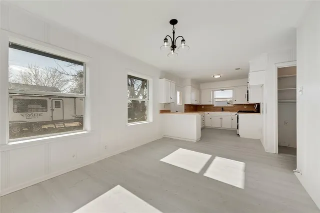 a view of kitchen with windows and refrigerator