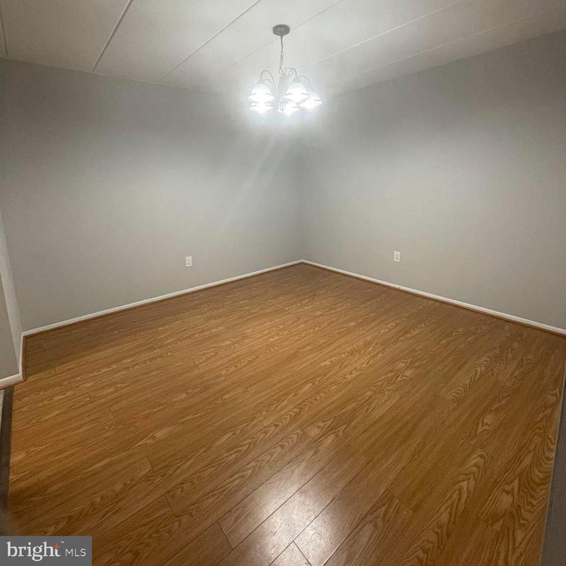 2628-00 Welsh Road, Unit 111 Philadelphia, PA 19152 - Photo 7 of 8 en empty room with wooden floor and windows