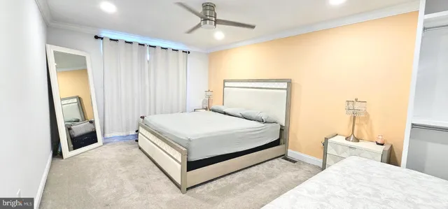 a bedroom with a bed and a mirror