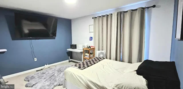 a bedroom with a bed and a television
