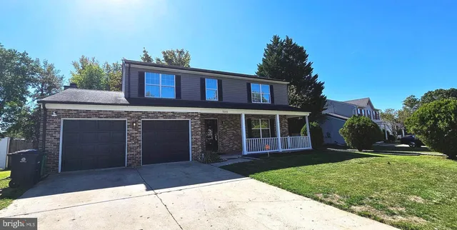 a view of a brick house with a yard