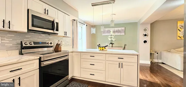 a kitchen with stainless steel appliances a stove microwave and cabinets